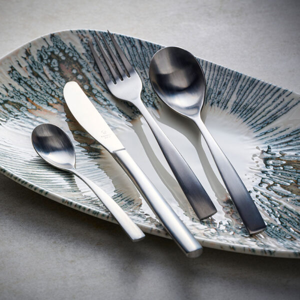 Comas Utensils in Silver layed over Churchill Inked Lyra Organic Platter