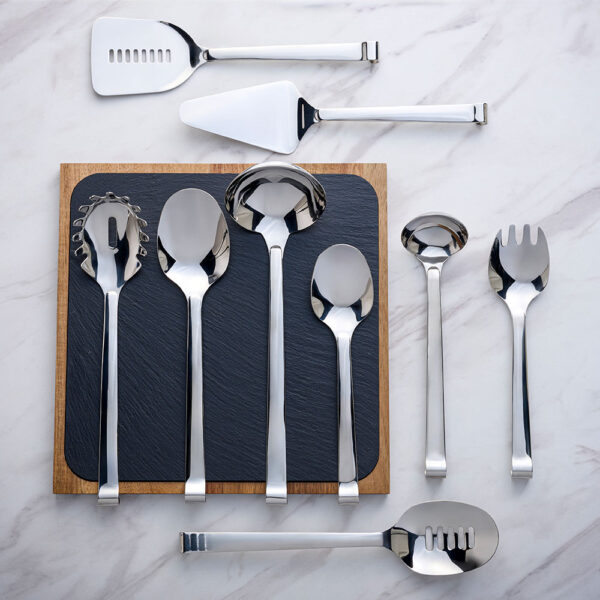 Silver Comas Utensils arranged on a Comas Slate Board, placed on a marble tabletop