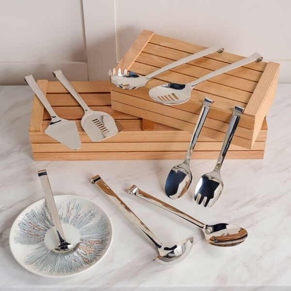 Silver Comas Utensils arranged on a Comas Wooden Boxes placed on a marble tabletop
