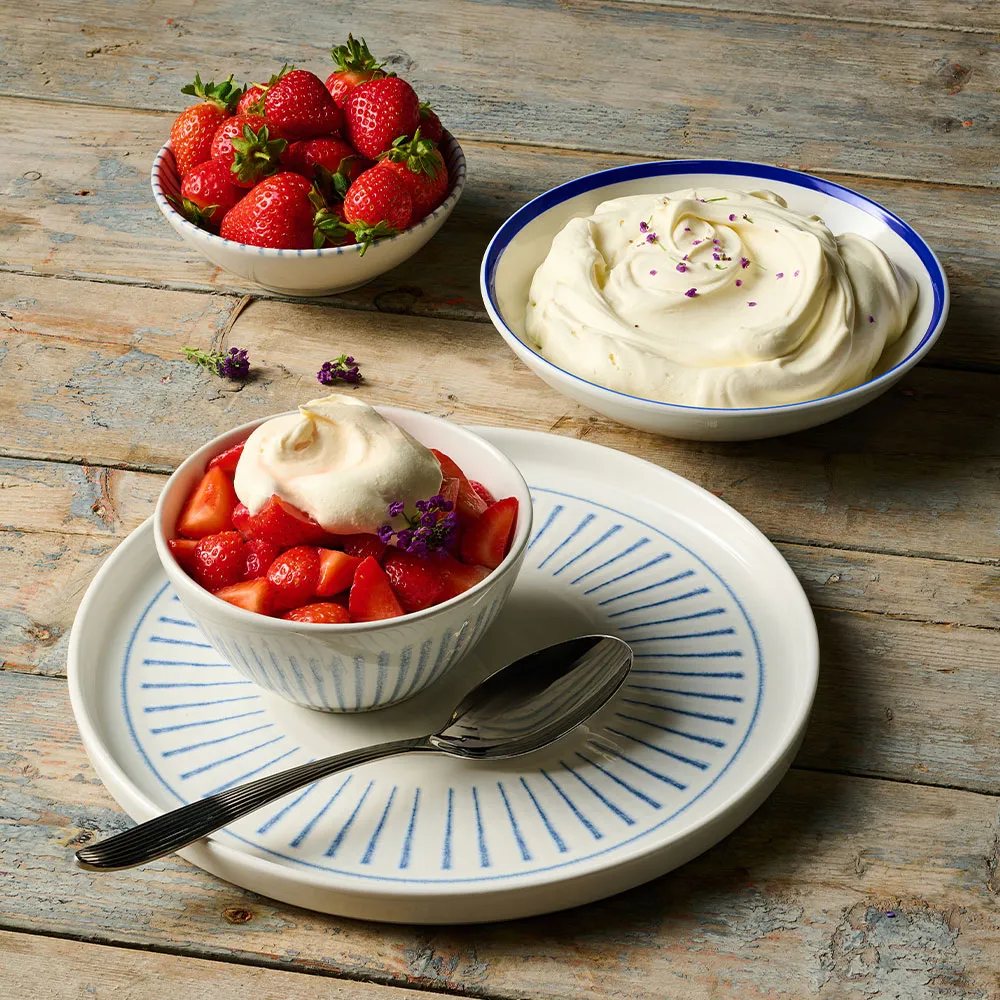 Churchill Inked Era Blue Walled Plate with matching dip pots, presenting strawberries and cream dessert on a wooden tabletop