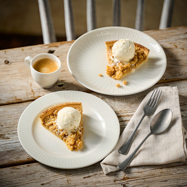 Churchill Inked Era White and Era Grey Coupe Plate serving up an apple pie on the tabletop, with a cup of tea to the side