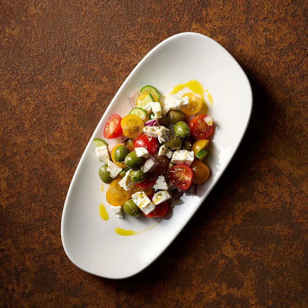 Colourful salad presented on Churchill Opal White Opal Platter on a dark background