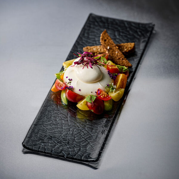 Churchill Viana Glass Dusk Tasting Trays served up a burrata salad with fresh tomatoes, greens, and a pop of purple flower on the top